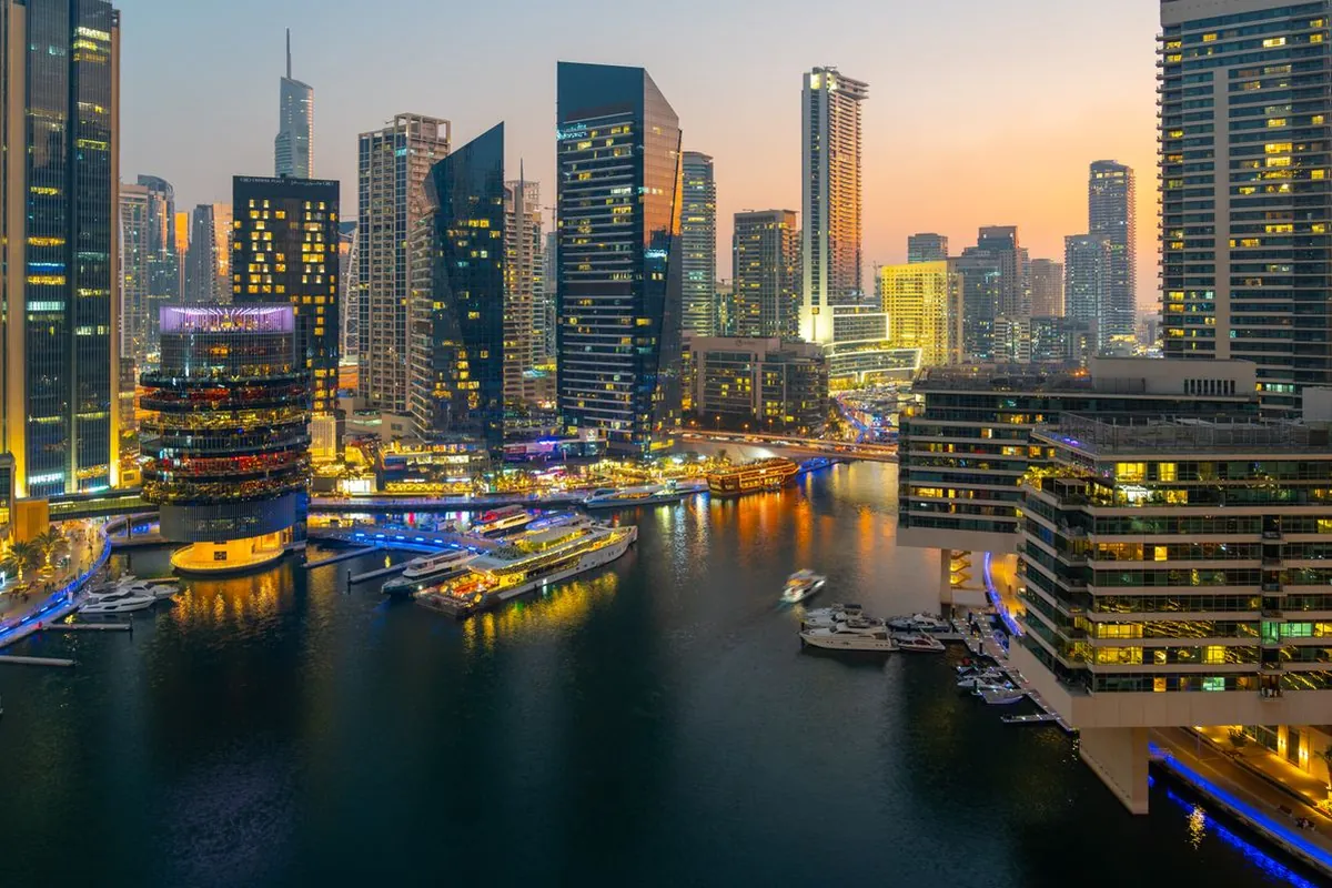 Dubai Marina skyline at dusk with illuminated residential towers
