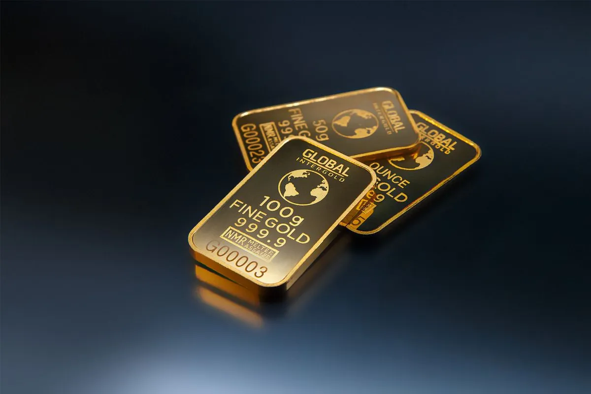 Stacked 100g fine gold bars for 24K vs 22K investment comparison