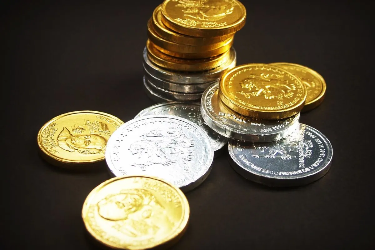 Gold and silver bars side by side on dark velvet