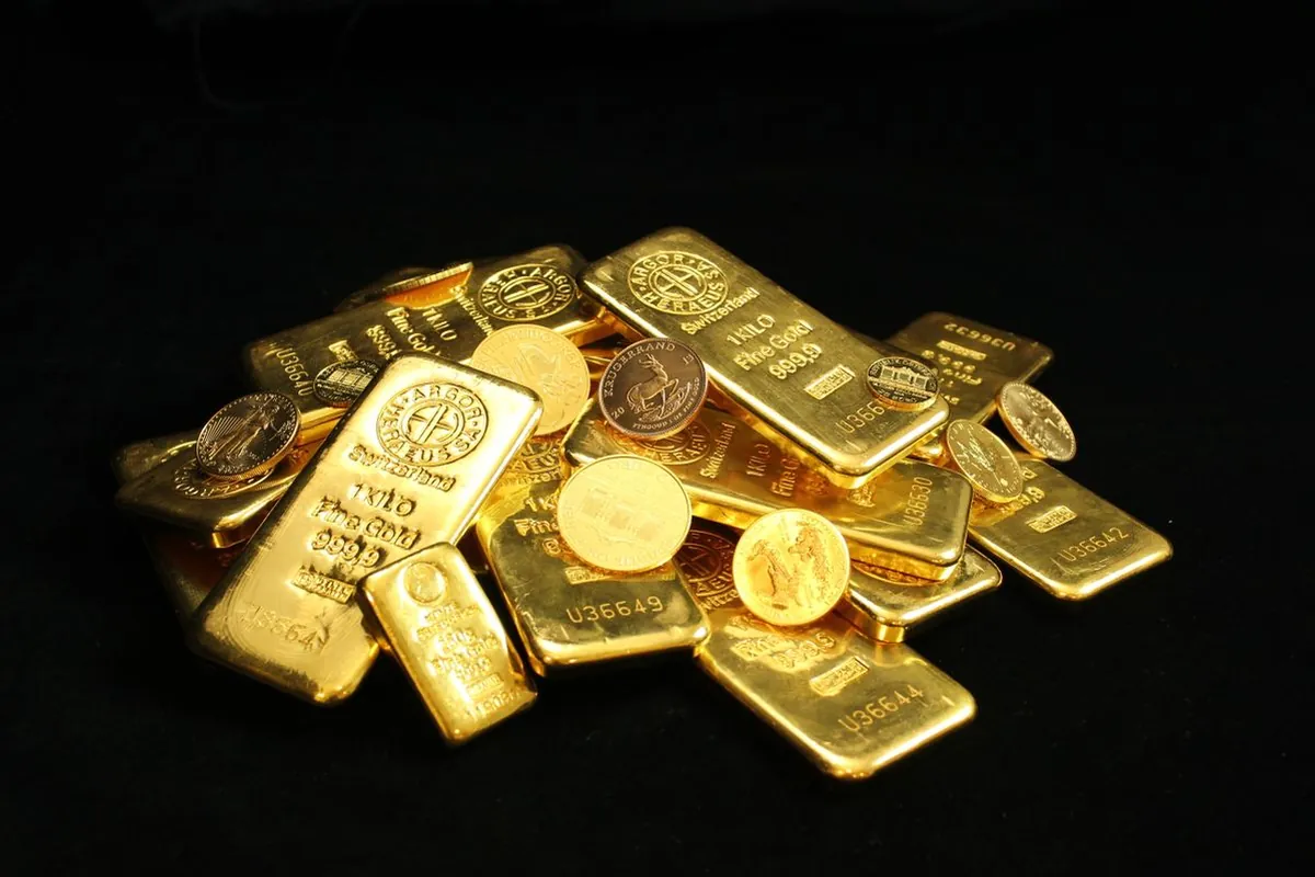 Pile of gold bars and gold coins
